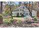 Beautiful two-story home featuring a covered porch and a well-manicured lawn with flowering plants at 4233 Lady Banks Ln, Ravenel, SC 29470