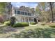 Charming two-story home with a inviting front porch, black shutters and mature landscaping at 4233 Lady Banks Ln, Ravenel, SC 29470