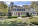 Inviting two-story home with a charming front porch and a bright red front door at 4233 Lady Banks Ln, Ravenel, SC 29470