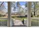 View of the front yard from the porch, showcasing a well-manicured lawn and mature trees at 4233 Lady Banks Ln, Ravenel, SC 29470