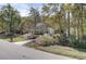 A charming home is nestled in a wooded lot and has beautiful flowering bushes in its front yard at 4233 Lady Banks Ln, Ravenel, SC 29470
