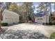 A long driveway leads to two garages and a home surrounded by blooming azaleas at 4233 Lady Banks Ln, Ravenel, SC 29470