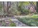 This garden features a variety of azaleas and other flowers, and a stone bench at 4233 Lady Banks Ln, Ravenel, SC 29470