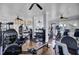 Bright gym with wood floors, ceiling fans, large windows, and fitness equipment at 4233 Lady Banks Ln, Ravenel, SC 29470