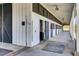 Well-maintained horse stable featuring individual stalls and a covered walkway for comfortable animal care at 4233 Lady Banks Ln, Ravenel, SC 29470