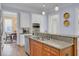 Kitchen features stainless steel appliances, white cabinets, and a view to the dining area at 4233 Lady Banks Ln, Ravenel, SC 29470