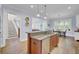 This kitchen features an island, hardwood floors, and an open floor plan at 4233 Lady Banks Ln, Ravenel, SC 29470