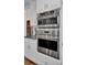 This kitchen features stainless steel double ovens and white cabinets at 4233 Lady Banks Ln, Ravenel, SC 29470