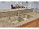 Kitchen sink has granite countertops with an open view to the living room at 4233 Lady Banks Ln, Ravenel, SC 29470