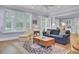 Sunlit living room featuring comfortable seating, hardwood floors, and french doors at 4233 Lady Banks Ln, Ravenel, SC 29470