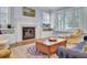 Comfortable living room with fireplace, built-ins, and a large window at 4233 Lady Banks Ln, Ravenel, SC 29470