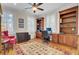 Home office with built-in wooden bookshelves and a large oriental rug at 4233 Lady Banks Ln, Ravenel, SC 29470