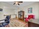 Home office with built-in wooden bookshelves and a large oriental rug at 4233 Lady Banks Ln, Ravenel, SC 29470