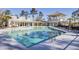 Community pool with zero depth entry, pool house and lounge chairs at 4233 Lady Banks Ln, Ravenel, SC 29470