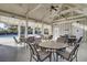 A covered lounge area in a pool house, with tables and chairs, provides a comfortable spot for relaxation at 4233 Lady Banks Ln, Ravenel, SC 29470