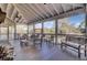 Spacious screened-in porch with fireplace and plenty of seating for guests at 4233 Lady Banks Ln, Ravenel, SC 29470