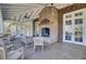 Screened in porch featuring a brick fireplace and comfortable seating area at 4233 Lady Banks Ln, Ravenel, SC 29470