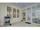 Outdoor porch with seating and BBQ area with plenty of natural light from the surrounding windows and door at 4233 Lady Banks Ln, Ravenel, SC 29470