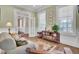 Comfortable sitting area featuring hardwood floors, a sofa, a side table, and natural light at 4233 Lady Banks Ln, Ravenel, SC 29470