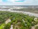 An aerial view showing the house nestled in a wooded community close to the water at 4291 Turtle Landing Ct, Johns Island, SC 29455