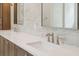 Bathroom vanity featuring double sinks with chrome faucets, quartz counters, and white marble backsplash at 4291 Turtle Landing Ct, Johns Island, SC 29455