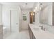 Contemporary bathroom features double sinks, marble floors and backsplash, and a separate room for the toilet at 4291 Turtle Landing Ct, Johns Island, SC 29455