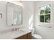 Elegant bathroom features a vanity with quartz countertop and framed mirror at 4291 Turtle Landing Ct, Johns Island, SC 29455