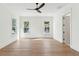 Spacious bedroom with wood floors, three windows, ceiling fan, and white walls with trim at 4291 Turtle Landing Ct, Johns Island, SC 29455