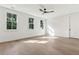Spacious bedroom featuring hardwood floors, three large windows and a ceiling fan at 4291 Turtle Landing Ct, Johns Island, SC 29455
