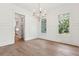 Elegant dining room with hardwood floors, wainscoting, and a modern chandelier at 4291 Turtle Landing Ct, Johns Island, SC 29455