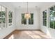 Bright dining room filled with natural light featuring large windows and hardwood floors at 4291 Turtle Landing Ct, Johns Island, SC 29455