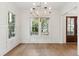Dining area featuring a pendant light fixture, wainscoting, two windows and an entry to another room at 4291 Turtle Landing Ct, Johns Island, SC 29455