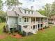 Inviting home with a spacious porch, screened in area, and a lush green lawn at 4291 Turtle Landing Ct, Johns Island, SC 29455