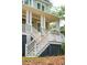 Close-up of a charming front porch with detailed railings, decorative columns, and a welcoming entrance at 4291 Turtle Landing Ct, Johns Island, SC 29455