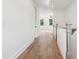 Light-filled hallway with hardwood floors and white walls at 4291 Turtle Landing Ct, Johns Island, SC 29455