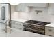 Close-up on the modern kitchen featuring a stainless steel range, farmhouse sink, and ample counter space at 4291 Turtle Landing Ct, Johns Island, SC 29455