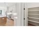 Open kitchen featuring modern white cabinets, stainless appliances, and a large pantry for additional storage at 4291 Turtle Landing Ct, Johns Island, SC 29455