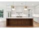 Beautiful kitchen with a large island, stainless steel refrigerator, and modern pendant lighting at 4291 Turtle Landing Ct, Johns Island, SC 29455