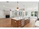 Open concept kitchen featuring stainless steel appliances, a spacious island, and views to the living room at 4291 Turtle Landing Ct, Johns Island, SC 29455
