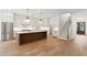 Bright, modern kitchen featuring a large island, stainless steel appliances, and open access to the staircase at 4291 Turtle Landing Ct, Johns Island, SC 29455