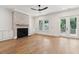 Living room with a brick fireplace, ceiling fan, cabinets and doors that go out to a porch at 4291 Turtle Landing Ct, Johns Island, SC 29455
