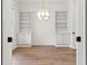 Cozy living room with custom built-ins, light hardwood floors, and modern pendant lighting fixtures at 4291 Turtle Landing Ct, Johns Island, SC 29455