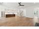 Open-concept living space with a kitchen, stairs, and hard wood floors that is well lit by recessed lights at 4291 Turtle Landing Ct, Johns Island, SC 29455