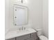 Stylish powder room with a gray vanity, modern mirror, and white countertop at 4291 Turtle Landing Ct, Johns Island, SC 29455