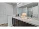 Bright bathroom featuring a double vanity, stylish lighting, a framed mirror, and a glass-enclosed shower at 4966 Hay Bale Ct, Summerville, SC 29485