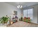 Comfortable living area featuring a chandelier, a guitar, and a green storage bench by the window at 4966 Hay Bale Ct, Summerville, SC 29485