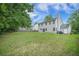 Large backyard with a well-maintained lawn and the rear view of the siding home at 5406 Woodbreeze Dr, North Charleston, SC 29420