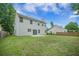 A spacious backyard with a well-kept lawn, patio and view of the home's rear exterior at 5406 Woodbreeze Dr, North Charleston, SC 29420