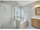 Bright bathroom featuring a glass shower, soaking tub, and vanity at 5406 Woodbreeze Dr, North Charleston, SC 29420