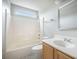 Clean bathroom featuring a shower-tub combination, white fixtures and marble flooring at 5406 Woodbreeze Dr, North Charleston, SC 29420